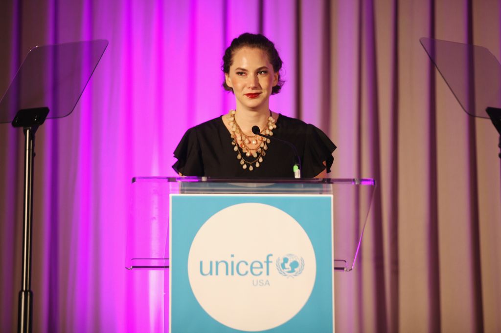 Emma speaking at a podium 