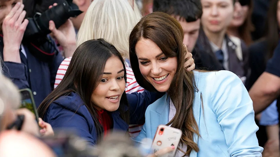 Kate Middleton taking a selfie with a fan.