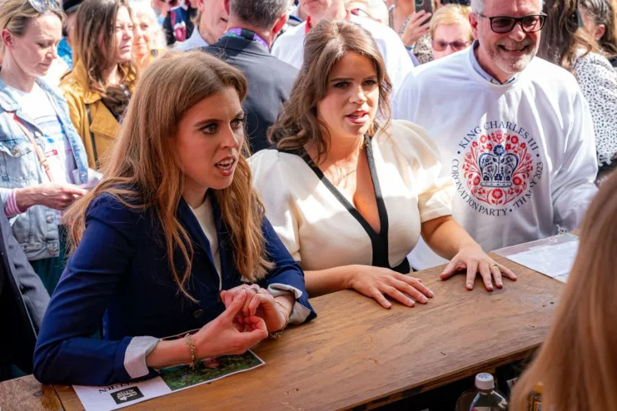 CHALFONT ST GILES, ENGLAND – MAY 07: Princess Beatrice of York (L) and Princess Eugenie of York attend a Coronation Big Lunch in Chalfont St Giles, Buckinghamshire on May 7, 2023 in Chalfont St Giles, England. People around the UK are celebrating with street parties after Charles III and his wife, Camilla, were crowned as King and Queen of the United Kingdom of Great Britain and Northern Ireland, and the other Commonwealth realms. The Coronation took place yesterday at Westminster Abbey eight months after Charles acceded to the throne on 8 September 2022, on the death of his mother, Elizabeth II. (Photo by Ben Birchall – WPA Pool/Getty Images)