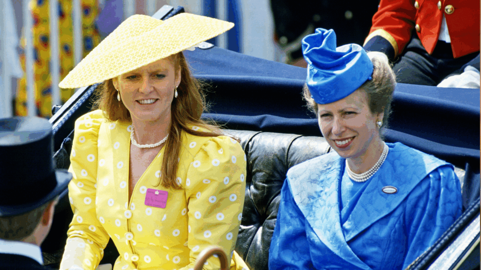 Princess Anne in a blue coat and Sarah Ferguson in a yellow dress and hat riding in a carriage at Royal Ascot 1987