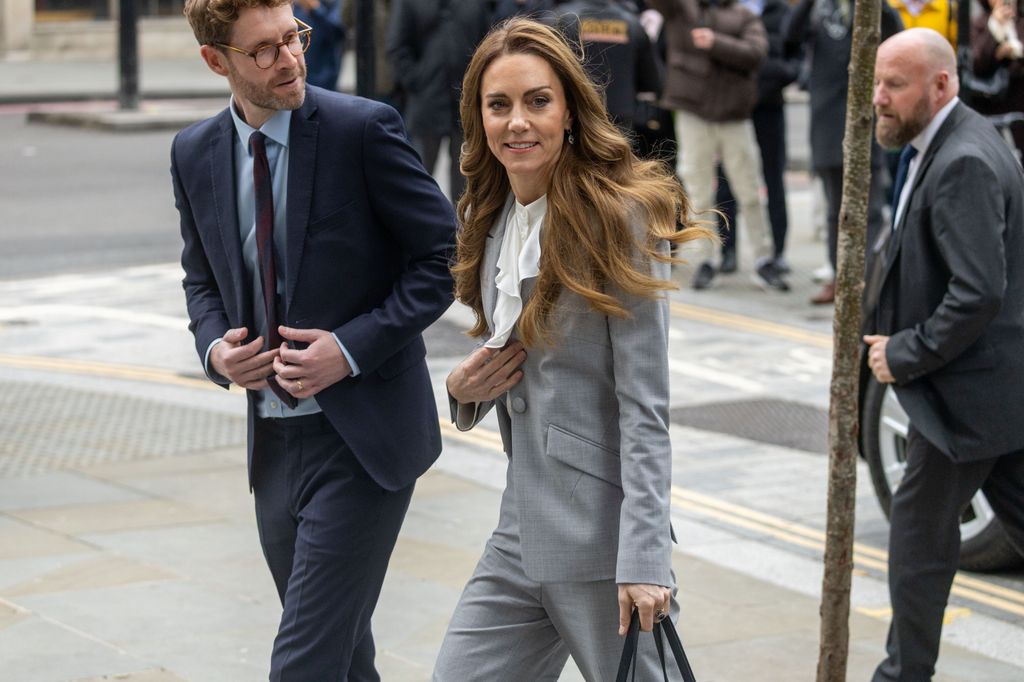 Kate Middleton in grey suit walking