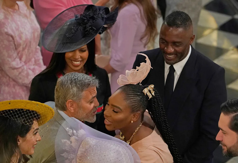 The stars gathered for Harry and Meghan’s wedding, but where are they now? Here, George Clooney greets Serena Williams as Idris Elba and Sabrina Dhowre look on, at St George’s Chapel on May 19, 2018, in Windsor, England. / WPA Pool / Getty Images