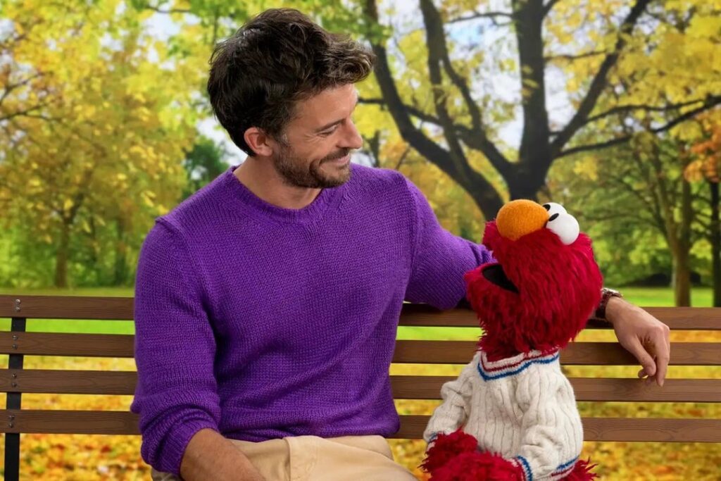 Jonathan Bailey with Elmo, Bert and Ernie on the set of Sesame Street