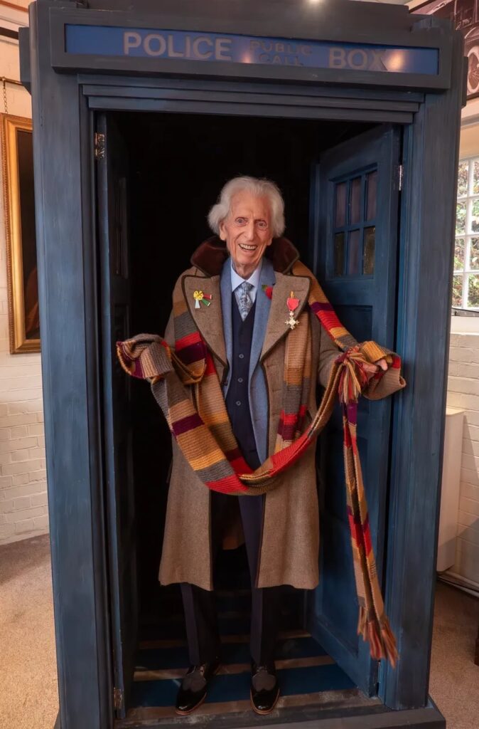 Doctor Who's Fourth Doctor, Tom Baker, aged 91, is honoured for his services to television with an MBE, supported by his former co-star Louise Jameson.