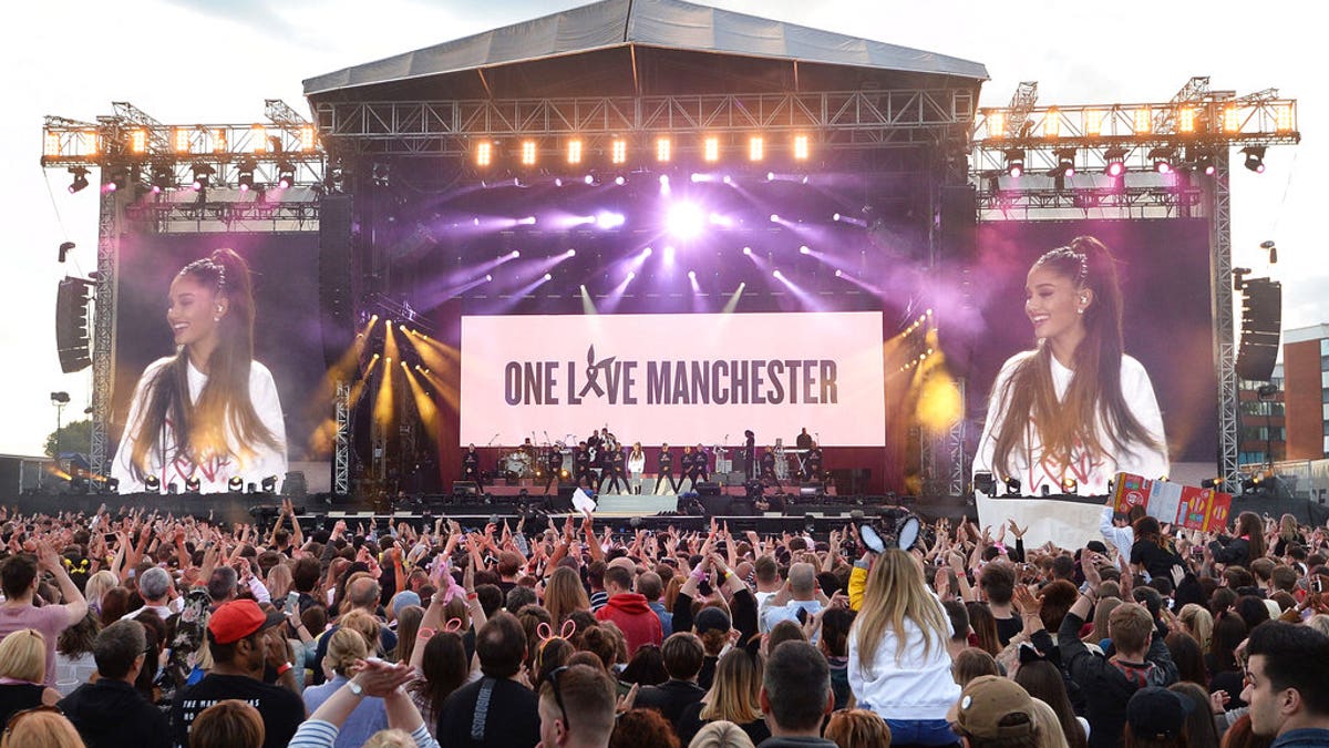 In this Sunday, June 4, 2017, handout photo provided by Dave Hogan for One Love Manchester, singer Ariana Grande, centre in white, performs at the One Love Manchester tribute concert in Manchester, north western England, Sunday, June 4, 2017. One Love Manchester is raising money for those affected by the bombing at the end of Ariana Grande's concert in Manchester on May 22, 2017. (Dave Hogan via AP)