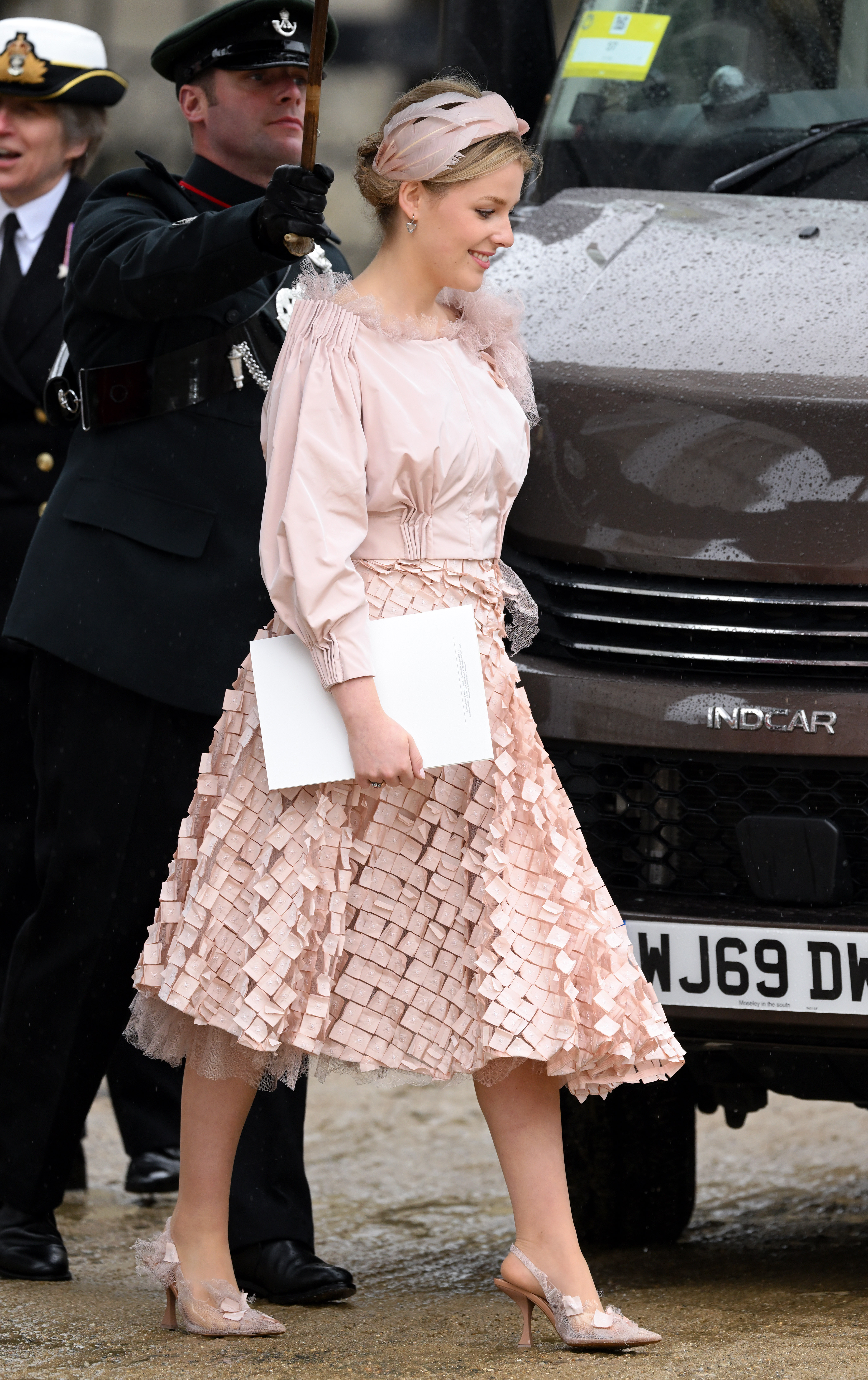 Lady Margarita Armstrong-Jones wearing a pink dress holding a program