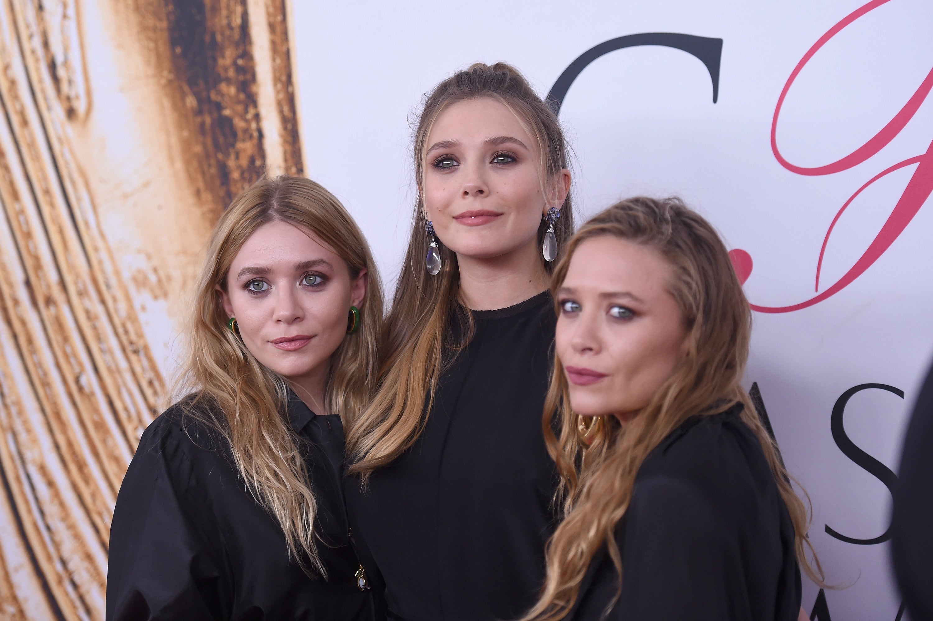 Elizabeth Olsen (middle) with her twin sisters Mary-Kate (left) and Ashley