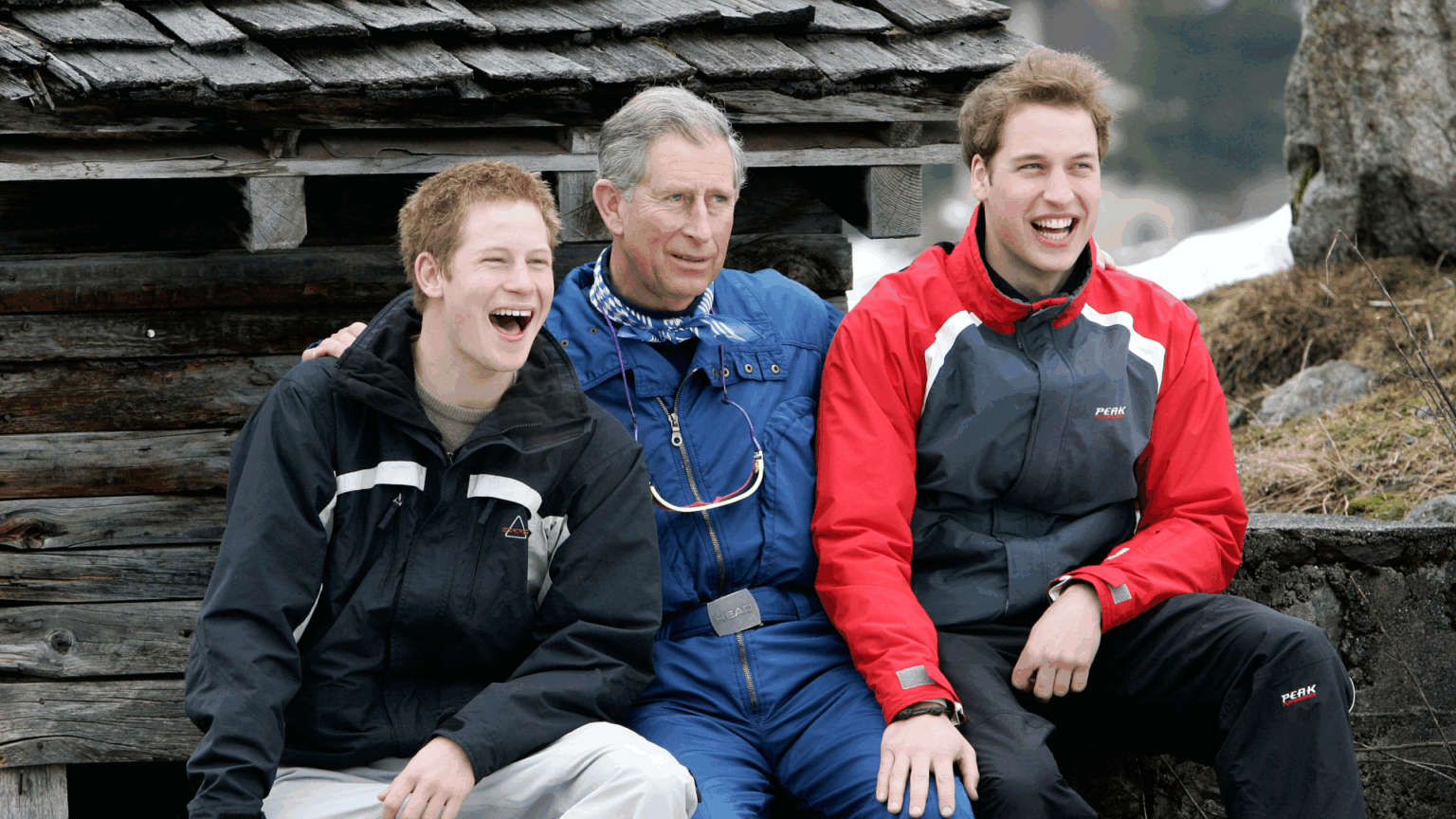 King Charles Once Had to Have the Cops “Check” In During “Funny” Incident at Prince Harry and Prince William’s Bonfire Night Party Prince William, Prince Harry and King Charles sitting next to each other wearing ski outfits and laughing