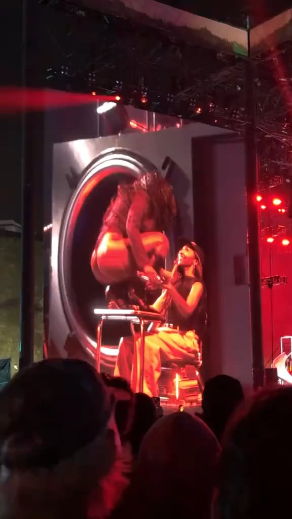 Doechii giving Ayo Edebiri a lap dance during her performance at Camp Flog Gnaw
