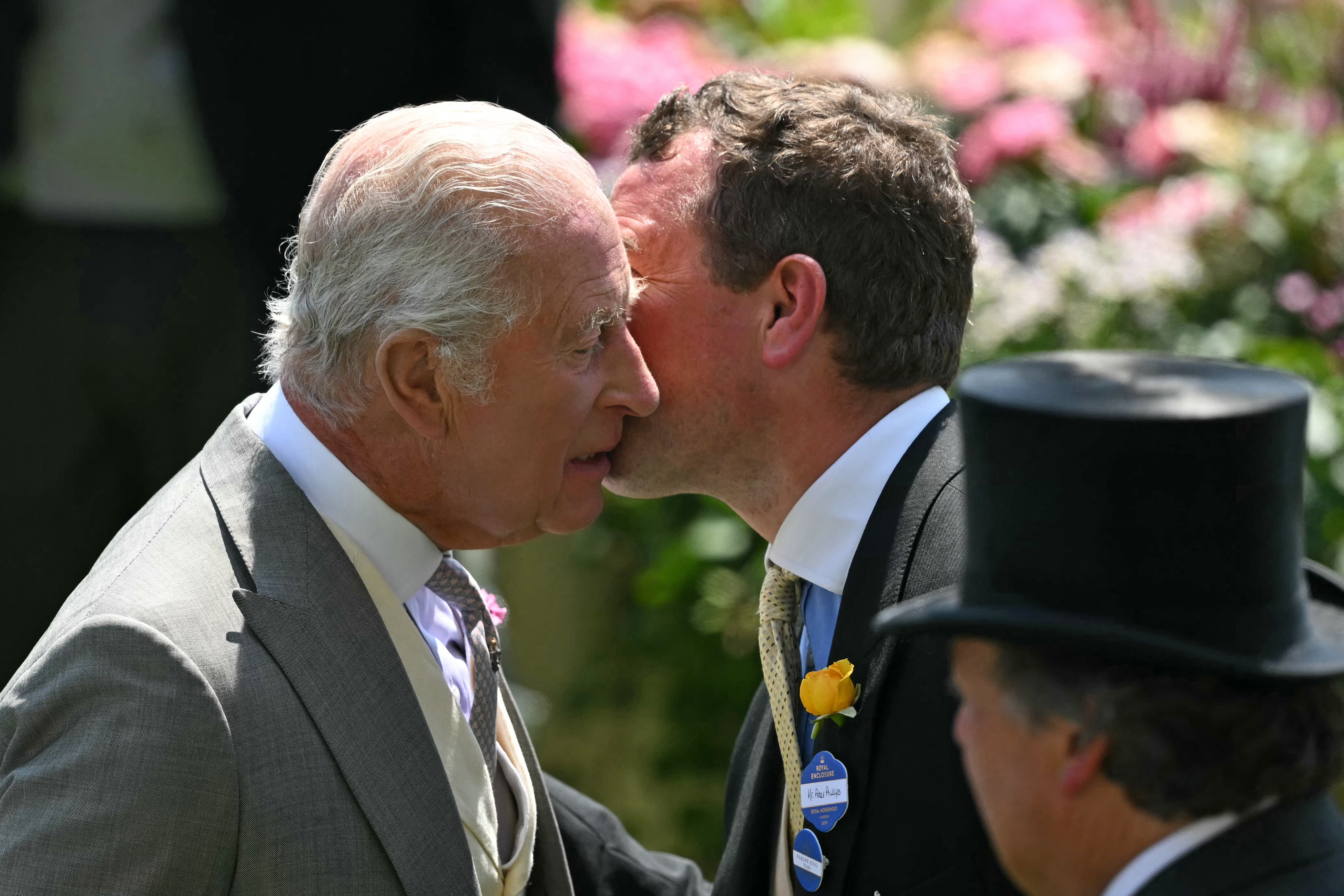 King Charles kissing nephew Peter Phillips at Royal Ascot