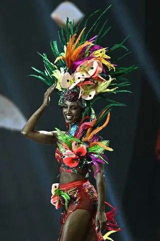 LILLIAN SUWANRUMPHA/AFP via Getty  Miss Jamaica, Gabrielle Henry walks on stage during the 2025 Miss Universe national costume presentation in Nonthaburi, north of Bangkok, on November 19, 2025