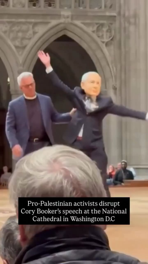 Pro-Palestinian activists disrupt Cory Booker’s speech at the National Cathedral in Washington D.C. one of the protesters was wearing a Benjamin Netanyahu mask