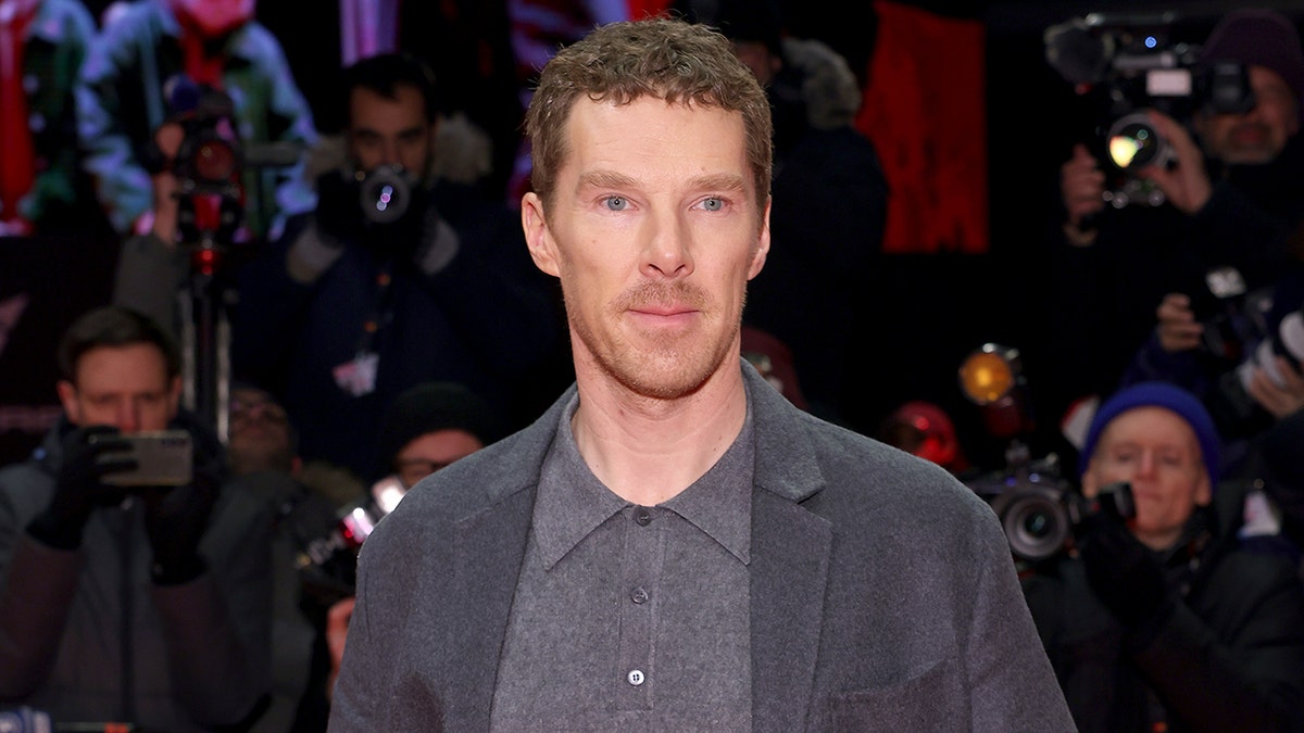 Benedict Cumberbatch posing in a gray suit