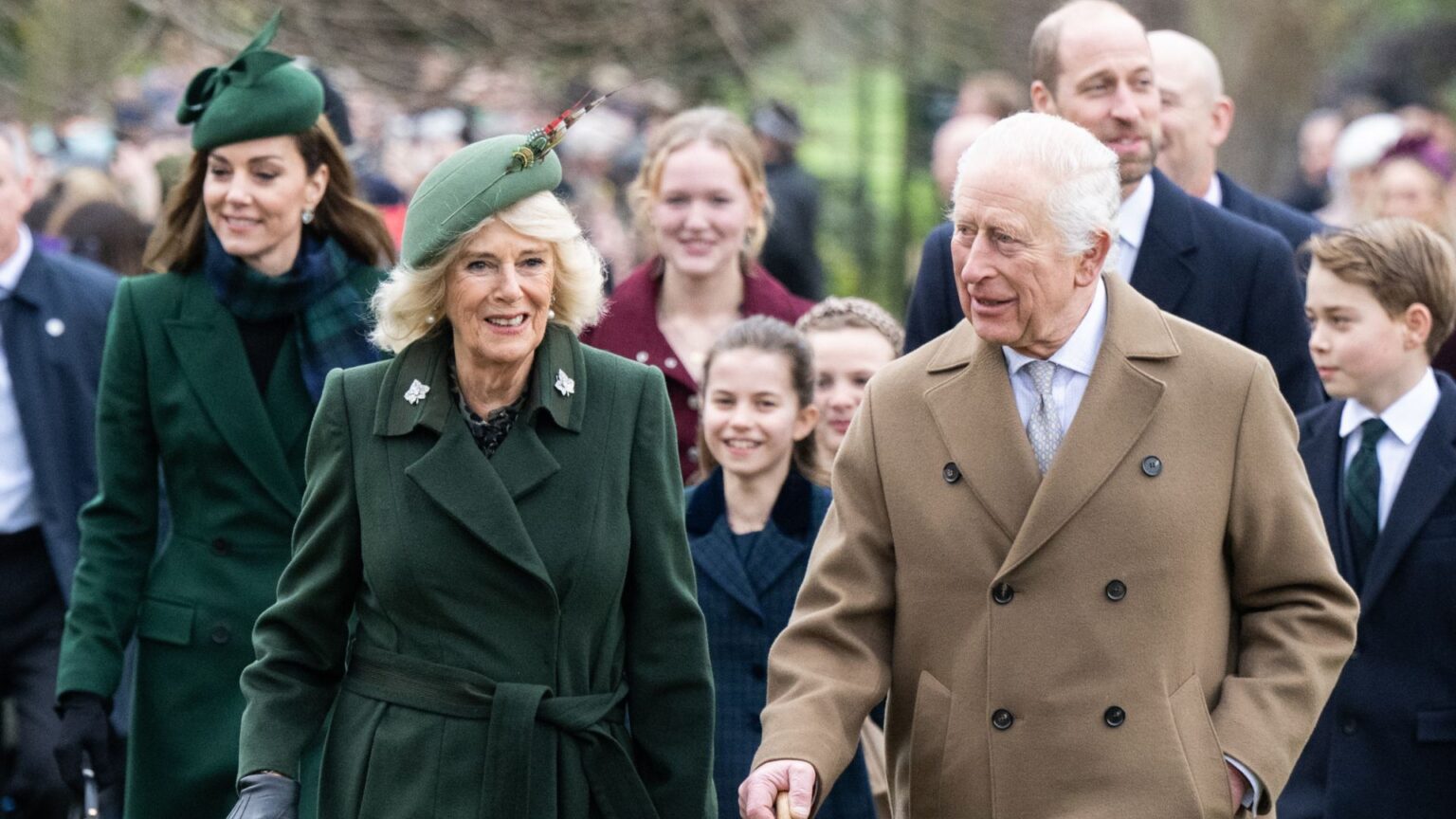 King Charles Fears Royal Christmas in Sandringham Is Ruined Kate Middleton, Queen Camilla and King Charles walking in wool coats on Christmas Day with Princess Charlotte, Prince William and Prince George behind them