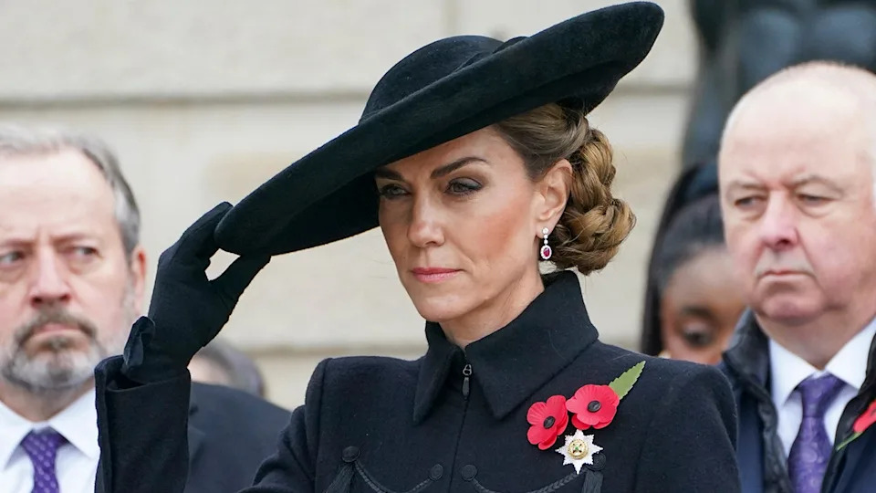 Kate Middleton tilting her hat as she wears all black.