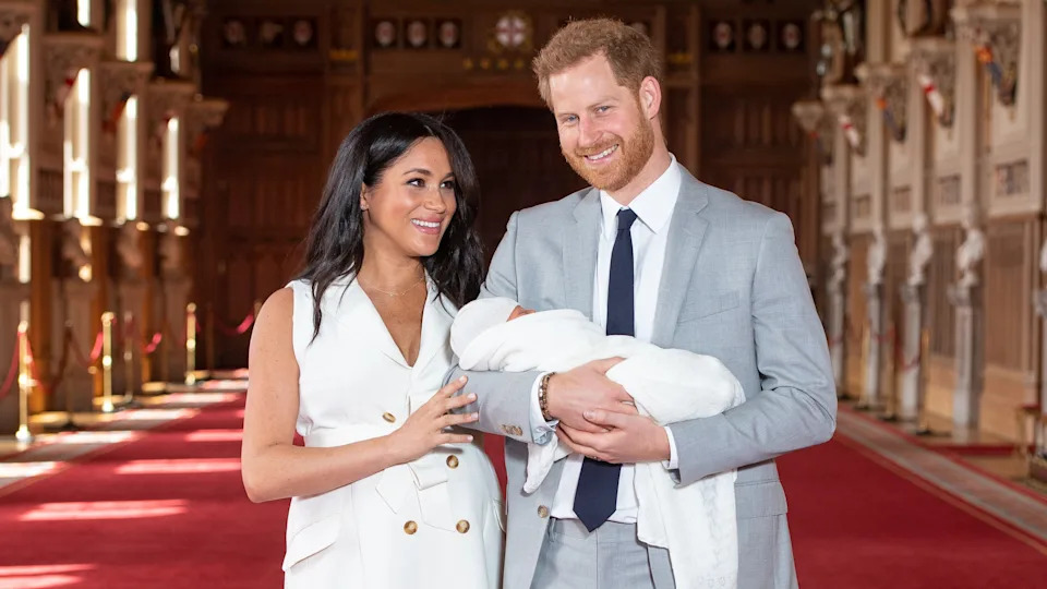 Prince Harry, and Meghan, Duchess of Sussex, pose with their newborn son Archie during a photocall in St George's Hall at Windsor Castle on May 8, 2019