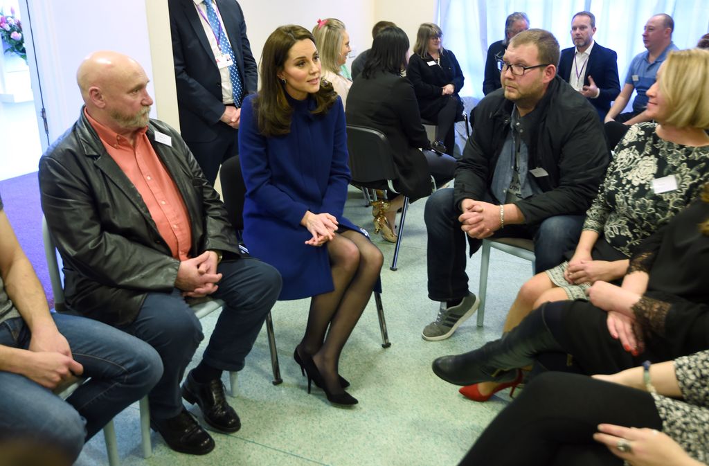 Kate talking in seated group of people