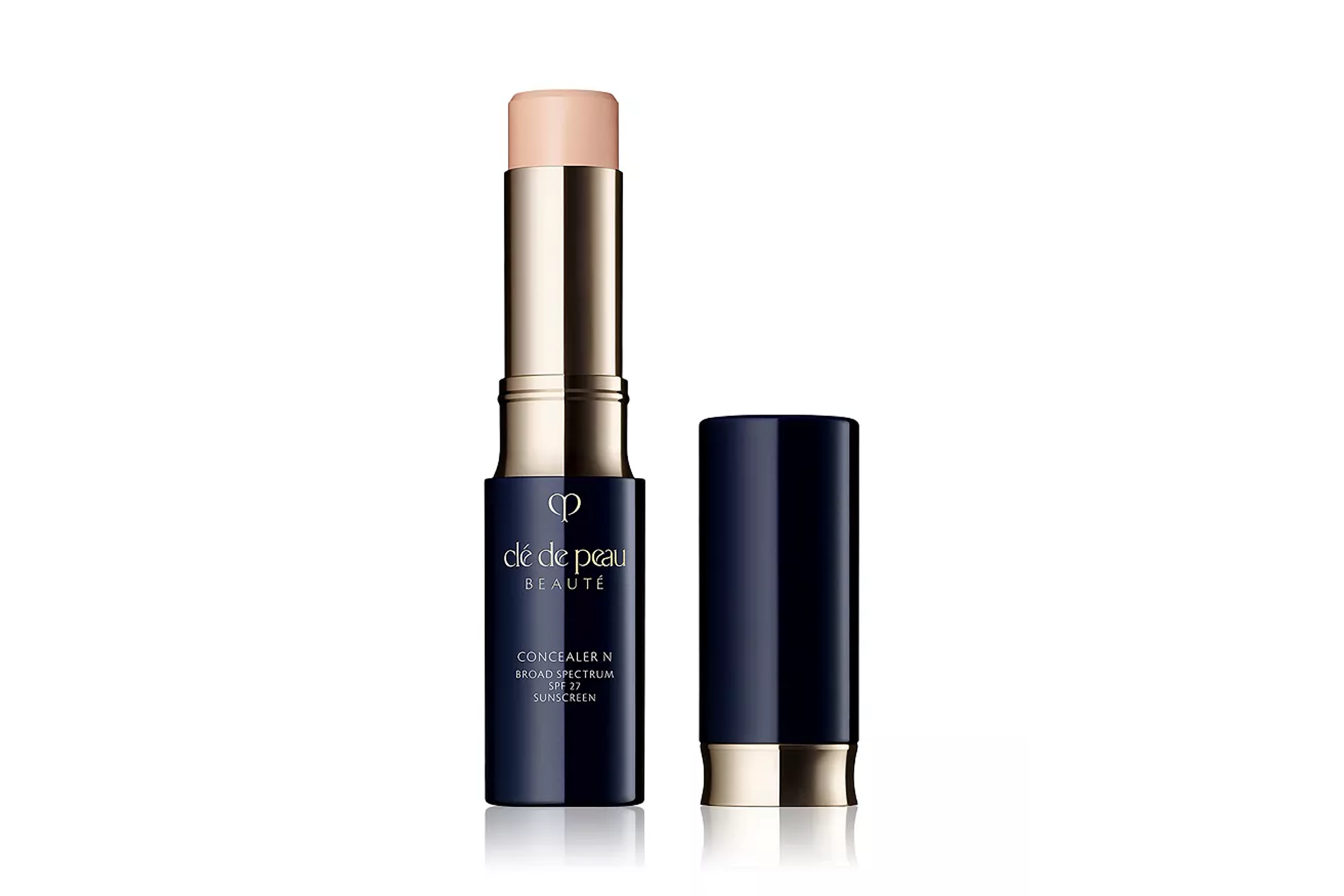 Clé de Peau Beauté Concealer N in a dark blue and gold tube with the cap off, revealing the light-colored concealer stick.