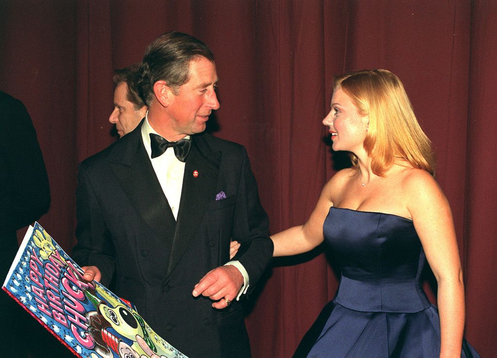 The Prince of Wales with former Spice Girl Geri Halliwell on his arm with a card presented to him backstage, after the Prince's Trust Comedy Gala at the Lyceum Theatre in London. 