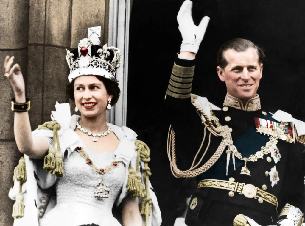 Queen Elizabeth II and Prince Philip wave on the balcony