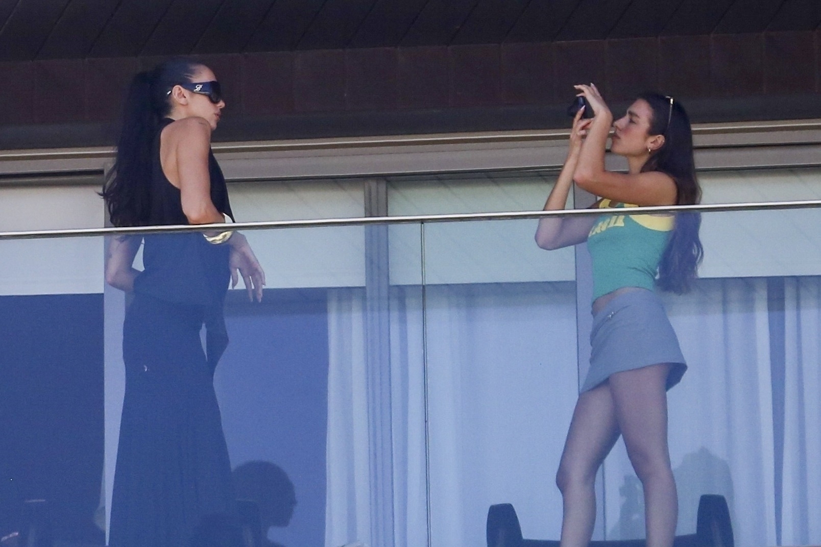 Dua Lipa was seen enjoying a fun moment with her sister, Rina Lipa, as they took photographs of each other on the balcony of Hotel Fasano in Ipanema, Brazil.