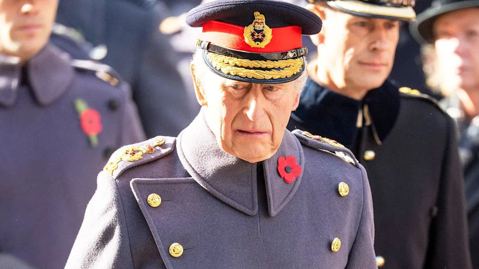 A close-up of King Charles looking withdrawn in his military uniform.