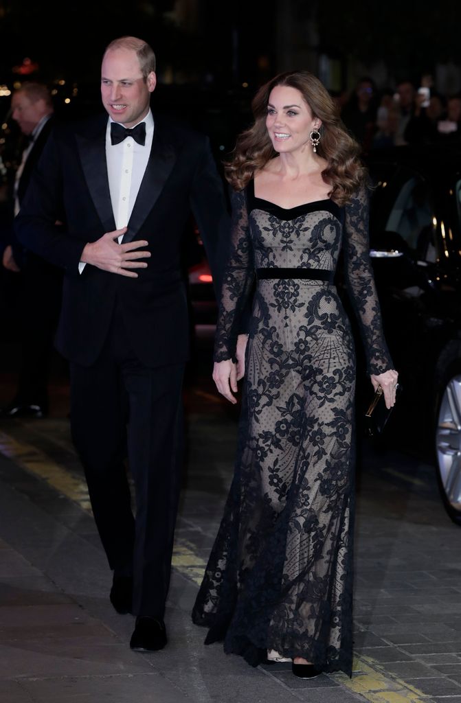 Kate Middleton in a black lace Alexander McQueen gown with a nude underlay and velvet trim, arriving at the Royal Variety Performance with Prince William.