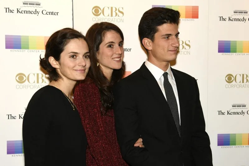Left to right, Siblings Rose Schlossberg, Tatiana and John Schlossberg pose for photographers as they arrive for the 2016 Kennedy Center Honors gala in Washington, D.C. File Photo by Mike Theiler/UPI