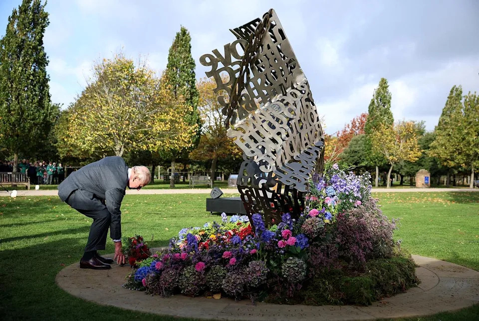Phil Noble - WPA Pool/Getty King Charles lays flowers at a new memorial dedicated to LGBT+ members of the British armed formers at the National Memorial Arboretum on Oct. 27, 2025