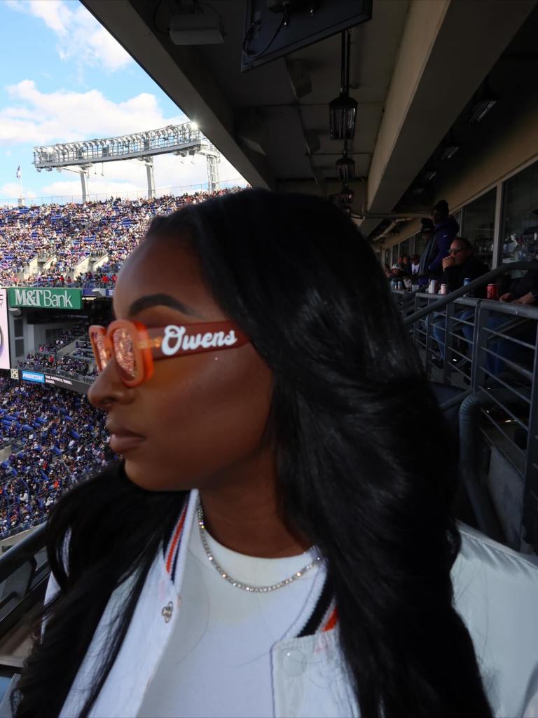 Simone Biles rocks some customized "Owens" sunglasses.