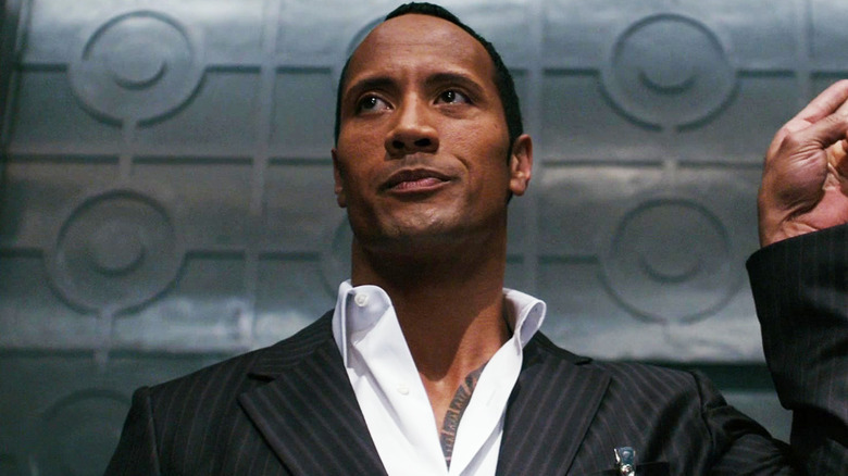 Dwayne Johnson as Agent 23 holds his arm up in closeup in Get Smart