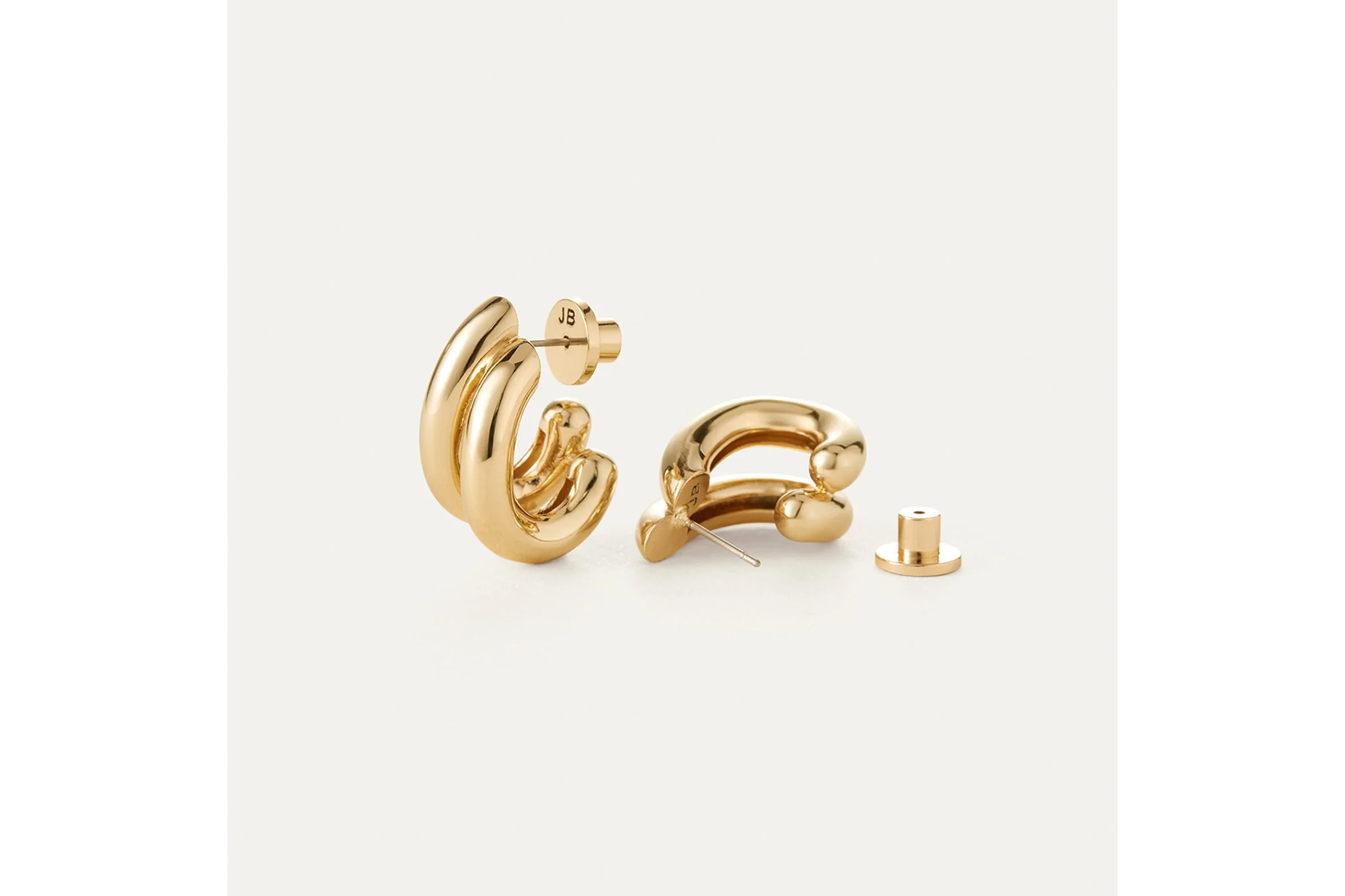 Pair of Jenny Bird gold-plated hoop earrings with screw backs.