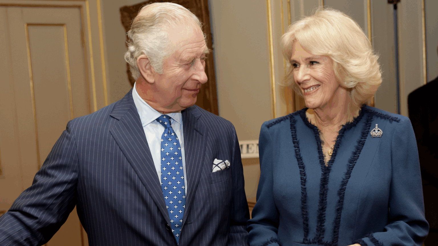 Expert Claims King Charles Relies Heavily on Queen Camilla King Charles and Queen Camilla smiling at each other in blue outfits