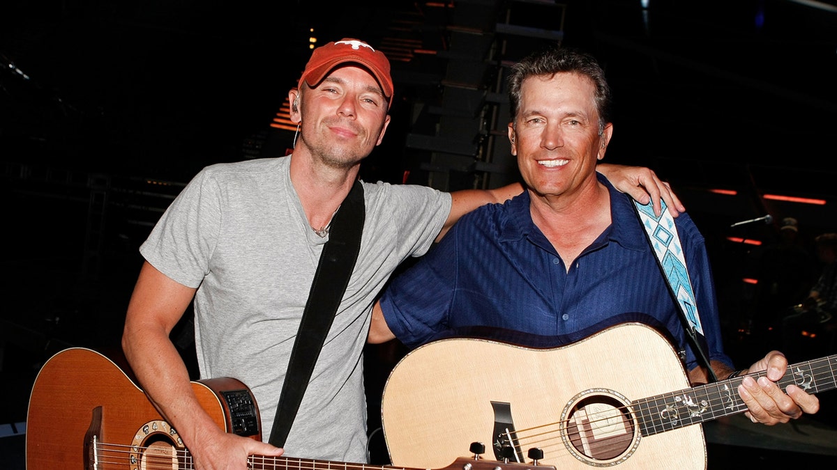 Kenny Chesney and George Strait smile for a photo