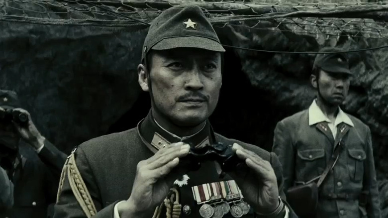 General Tadamichi Kuribayashi (Ken Watanabe) holding binoculars in Letters from Iwo Jima