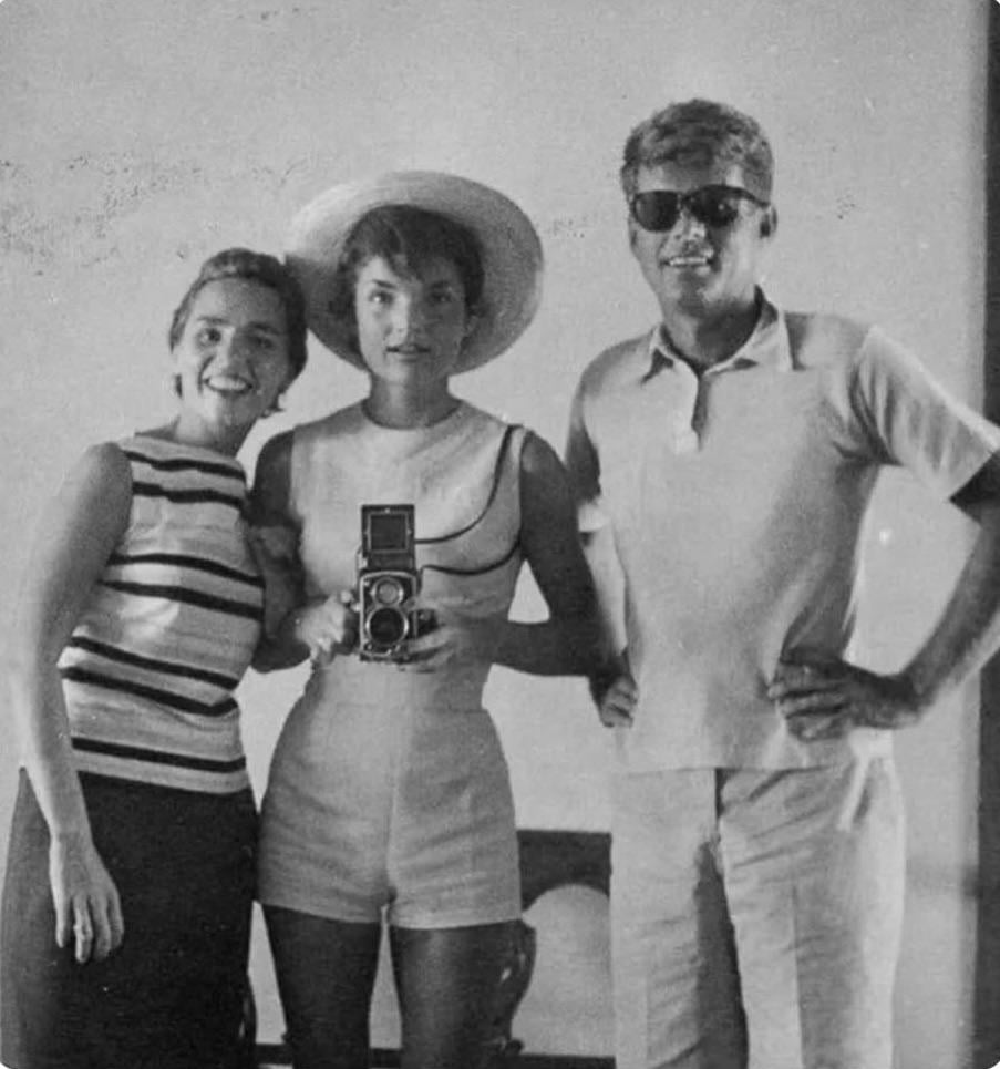 Jackie Kennedy, John F. Kennedy and Ethel Kennedy taking a mirror selfie with a 35mm camera in 1954