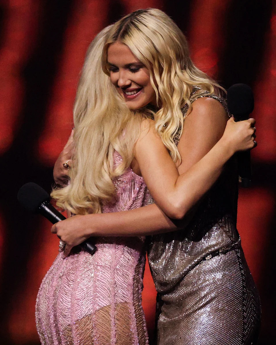British actress Millie Bobby Brown congratulates US actress and singer Sabrina Carpenter after she received the Global Success award during the BRIT Awards 2025 in London on March 1, 2025. (Adrian Dennis/AFP via Getty Images)
