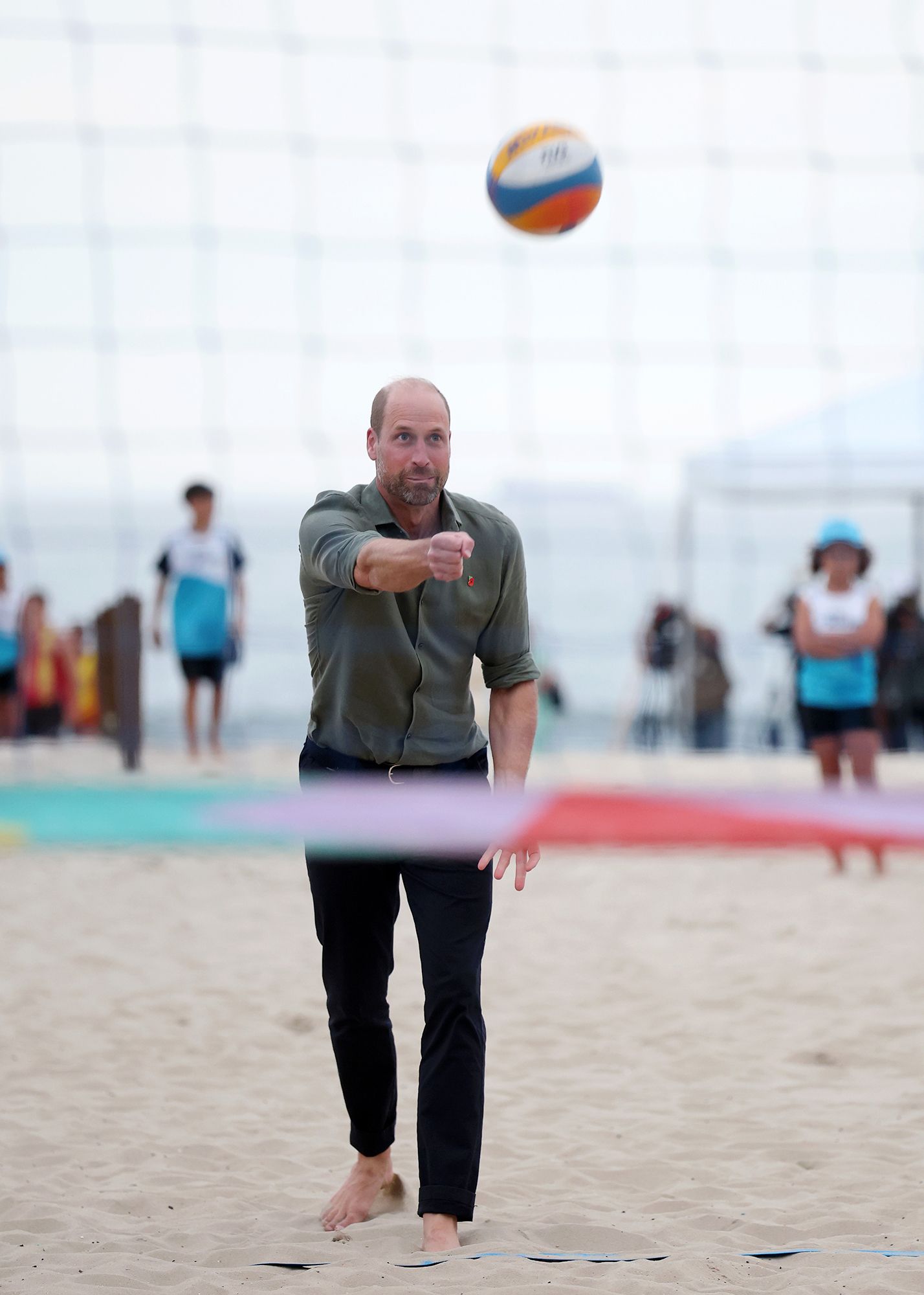 Prince William playing volleyball on Copacabana Beach.