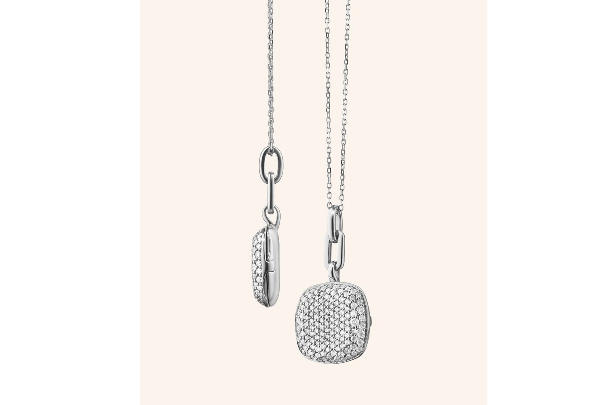 Two diamond-studded cushion-shaped charms dangling from silver chains.
