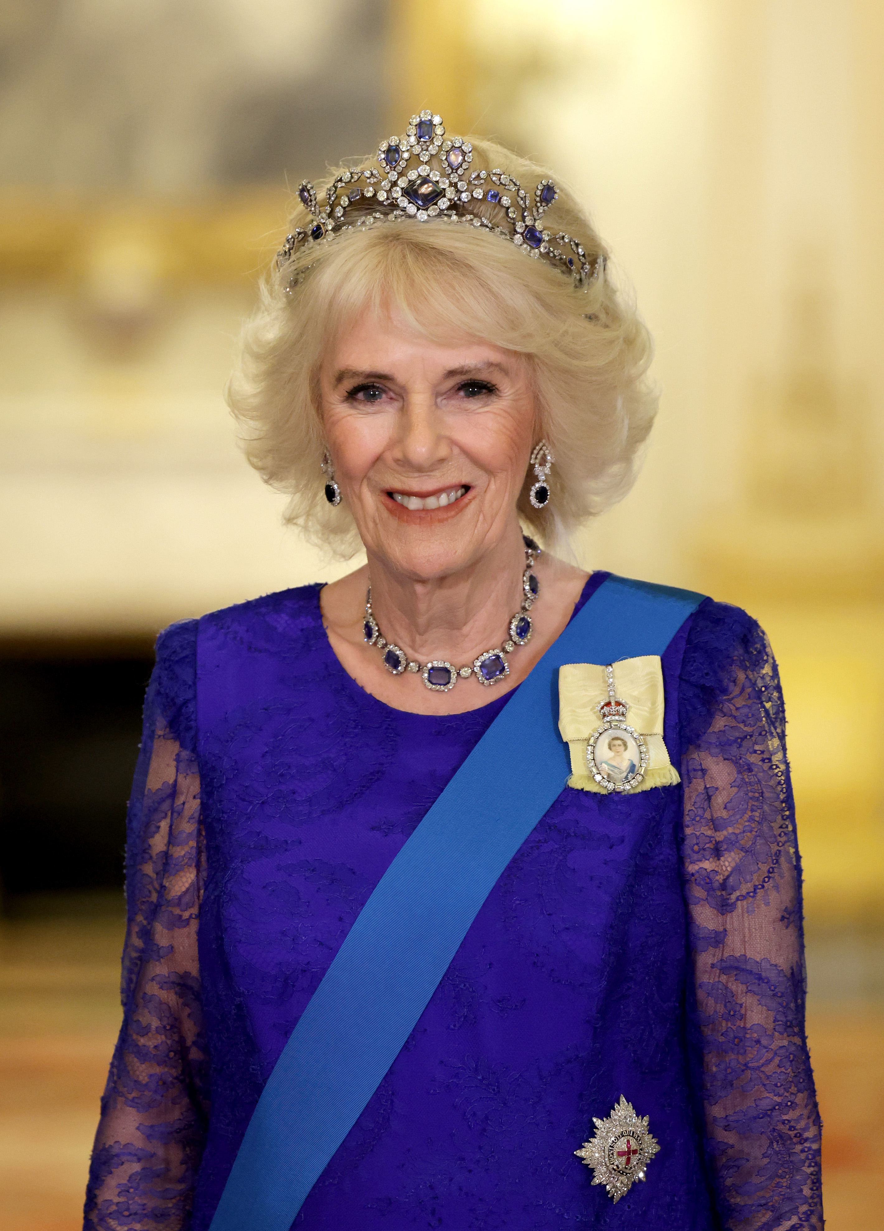 Queen Camilla wearing a blue lace gown and tiara