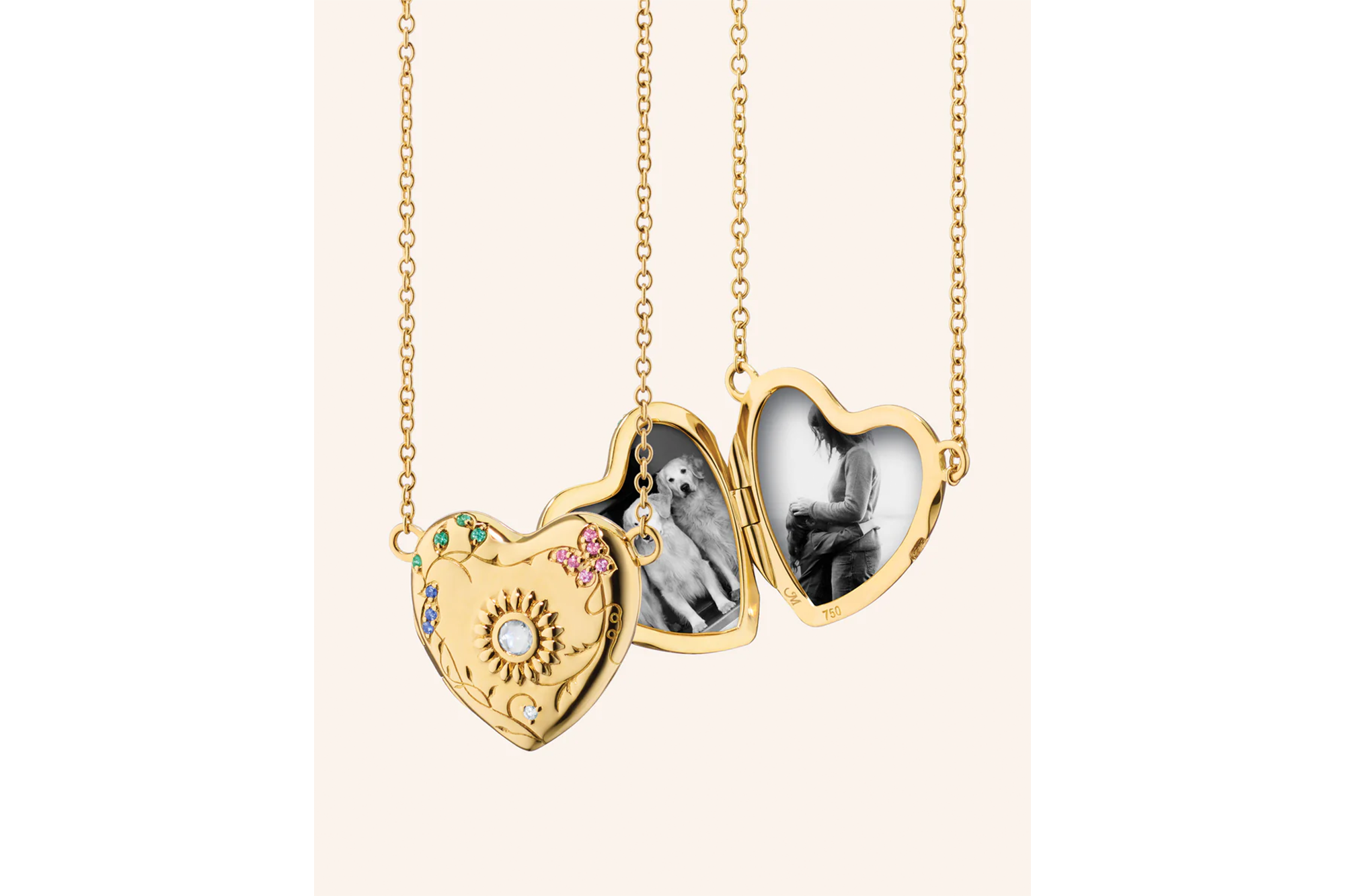 Three gold heart-shaped lockets on chains. The first is closed, adorned with gems and an engraved sun. The other two are open, revealing black and white photos of two dogs and a person.