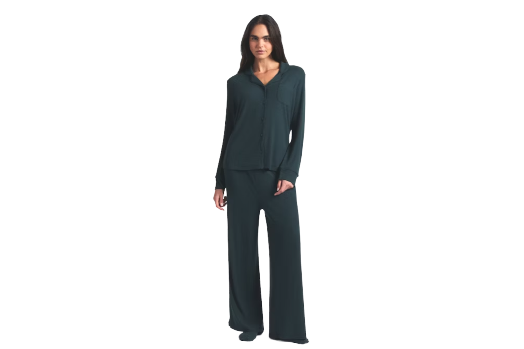 A woman wearing a dark teal pajama set, with a long-sleeved button-up top and wide-leg pants.