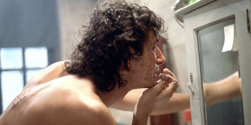 The-Fly-1986 - Jeff Goldblum looks at his decaying face closely in the mirror
