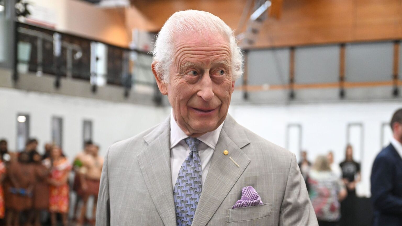 New Royal Book Claims that Working for King Charles These Days Can Feel Like “Treading on Eggshells” King Charles wearing a gray suit and raising his eyebrows