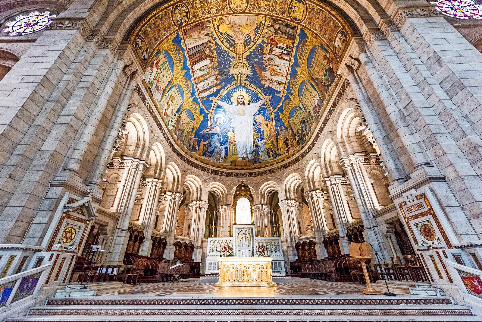 Interior of Sacré-Cœur Basilica in Paris, France, showing the altar and ceiling mosaic.