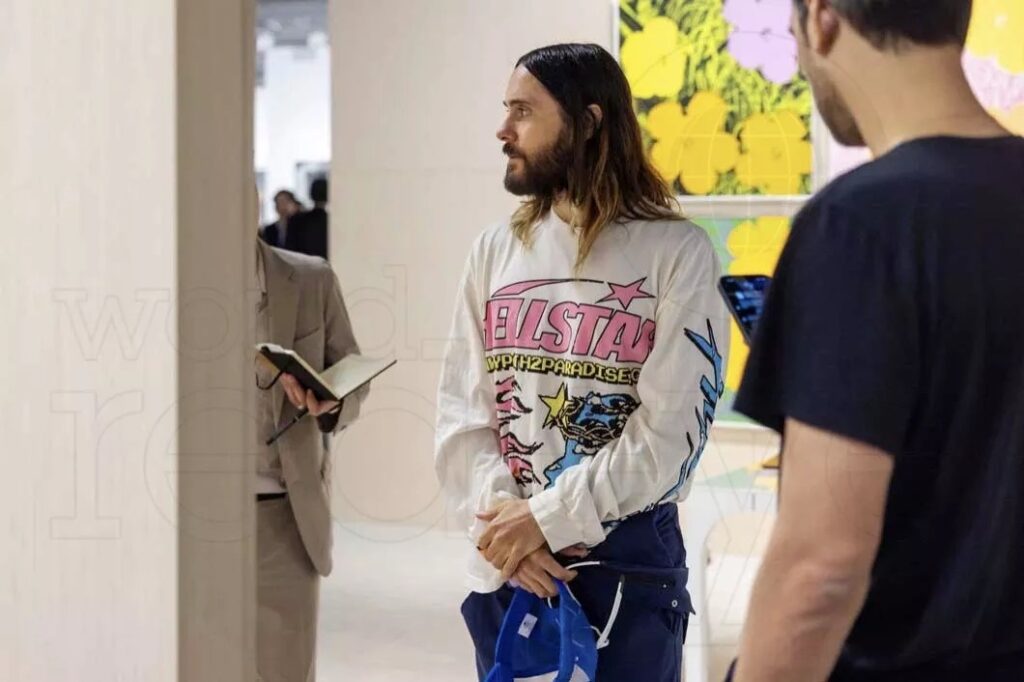 photo of actor Jared Leto walking through an art gallery