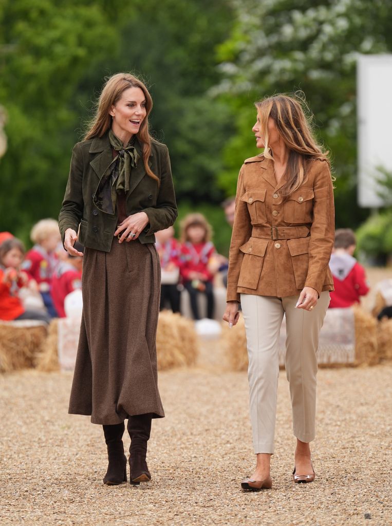 Catherine in green jacket and brown skirt and First Lady Melania Trump walking beside her in tan jacket and cream trousers