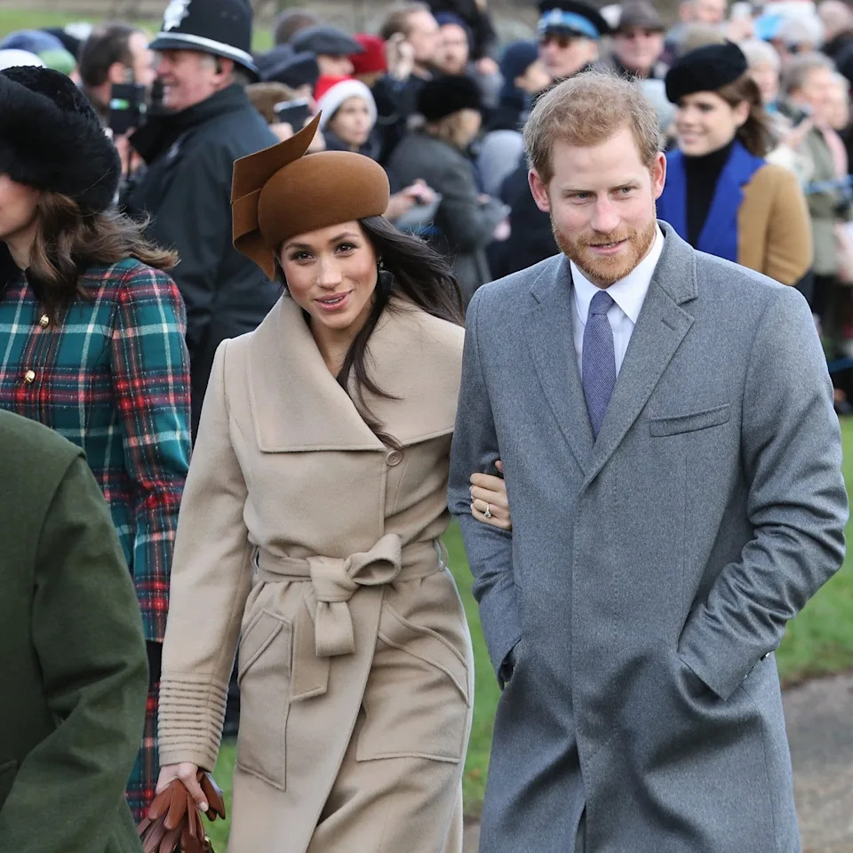 Meghan Markle wearing a beige Sentaler wrap coat and a brown Philip Treacy hat during the 2017 Royal Family Christmas Day walk at Sandringham.