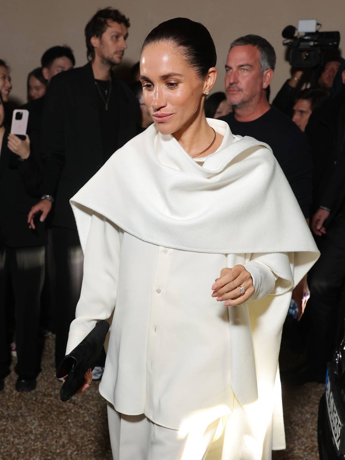 Meghan Marke pictured at Paris Fashion week in a white outfit