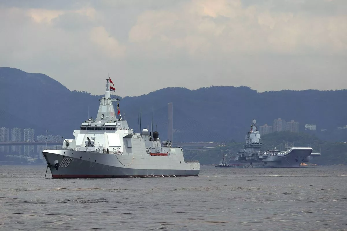 China's first domestically built aircraft carrier Shandong's (R) escort ship destroyer Yanan is anchored after arriving in Hong Kong on July 3, 2025. Commissioned in 2019, the 305-metre-long (1,000 feet) Shandong is China's second carrier and key to the country's regional ambitions under President Xi Jinping, who oversaw a massive naval buildup that has rattled Asian neighbours. (Photo by May JAMES / AFP) (Photo by MAY JAMES/AFP via Getty Images)